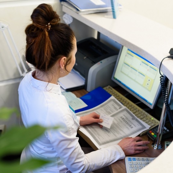 Periodontal team member typing on computer