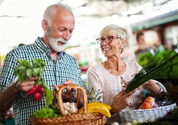 a mature couple getting groceries together