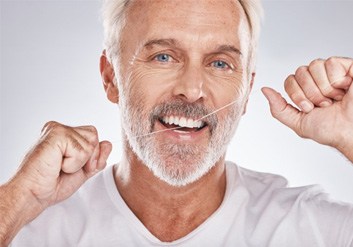 a man flossing his dental implants