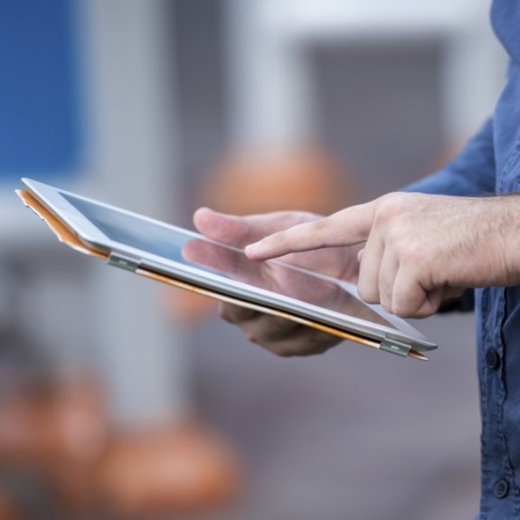 Dental team member typing on tablet