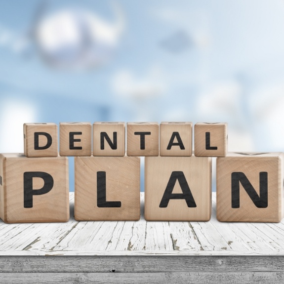 Wooden letter blocks spelling out the words dental plan