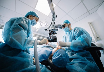 an oral surgeon performing dental implant placement surgery