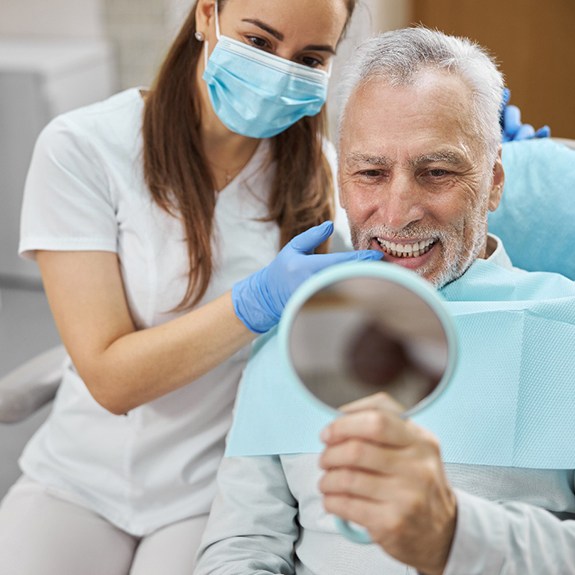 A patient consulting a dentist about implant denture treatment