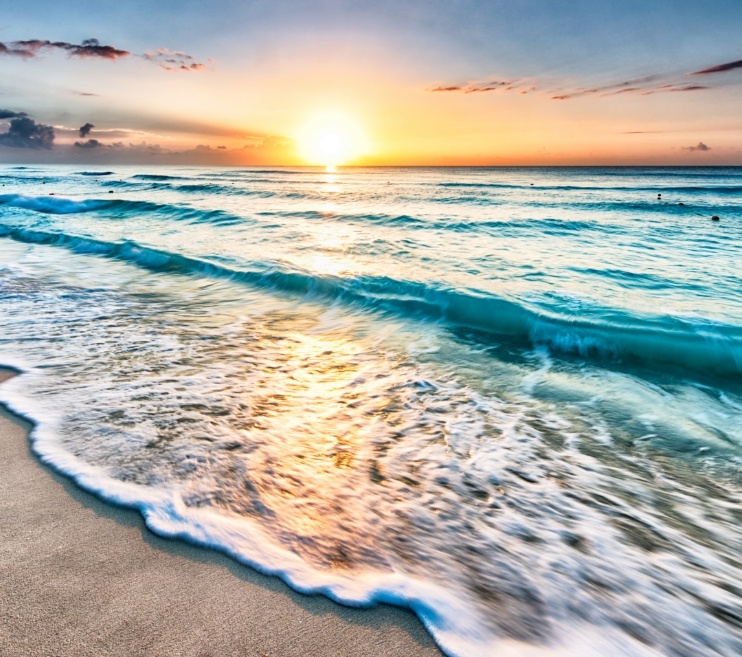 Waves on beach at sunset