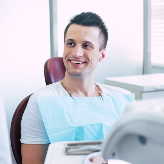 Smiling man sitting in dental chair