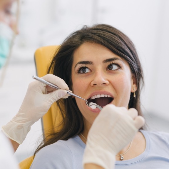 Dental patient opening her mouth for wisdom tooth extractions in Cranford
