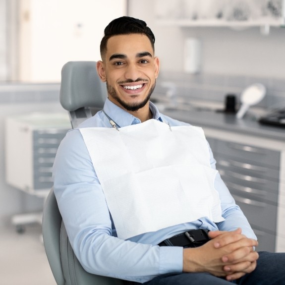 Smiling man sitting in dental chair